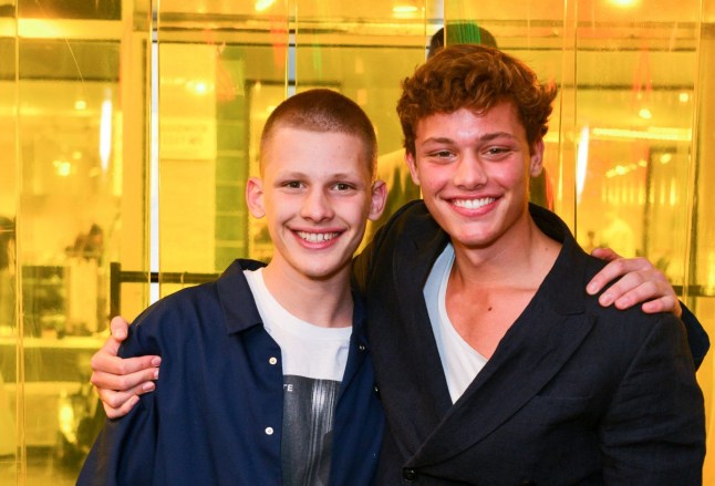 Freddy Brazier (L) and Bobby Brazier put arms around each other as they smile for pictures