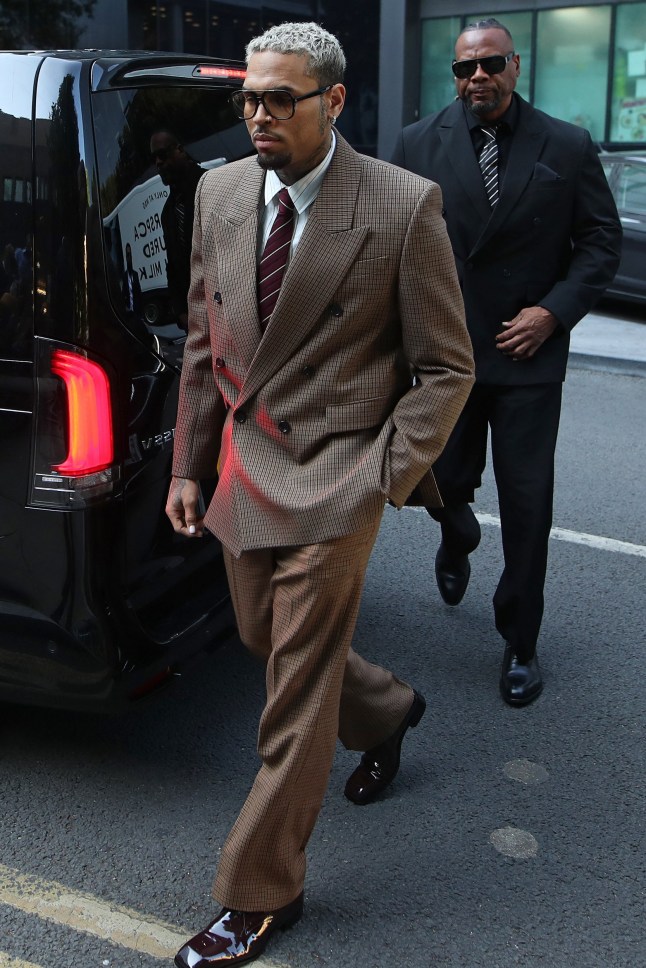 US rapper Chris Brown (L) arrives at Southwark Crown Court in London on July 11, 2025, to attend a plea hearing in the case against him for attempting to cause grievous bodily harm with intent during an alleged London nightclub brawl in 2023. (Photo by Rhianna Chadwick / AFP) (Photo by RHIANNA CHADWICK/AFP via Getty Images)