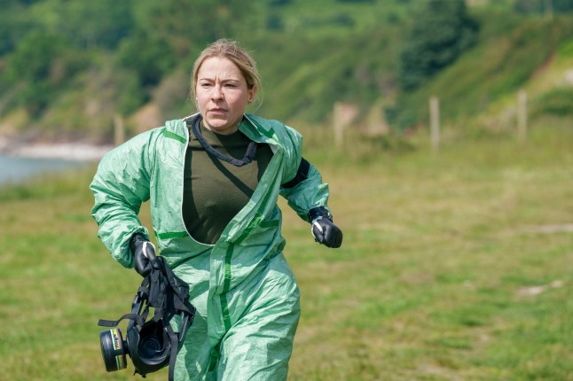 Pictured: Lucy Spraggan running in hazmat suit and gas mask in hand to Gassing task