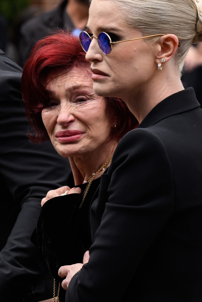 BIRMINGHAM, ENGLAND - JULY 30: (L-R) Sharon Osbourne and Kelly Osbourne leave after viewing tributes to the late Ozzy Osbourne from fans as his funeral cortege travels through his home city of Birmingham on July 30, 2025 in Birmingham, England. The Black Sabbath frontman passed away on July 22nd at the age of 76. His death occurred just a little over two weeks after his final live performance at the 'Back to the Beginning' concert in his hometown of Birmingham. (Photo by Leon Neal/Getty Images)