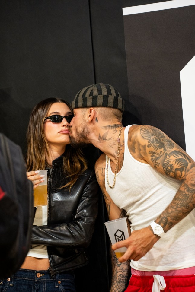LOS ANGELES, CALIFORNIA - AUGUST 28: Hailey Bieber and Justin Bieber kiss from the sidelines at "The League" on August 28, 2025 in Los Angeles, California. (Photo by Cassy Athena/Getty Images)