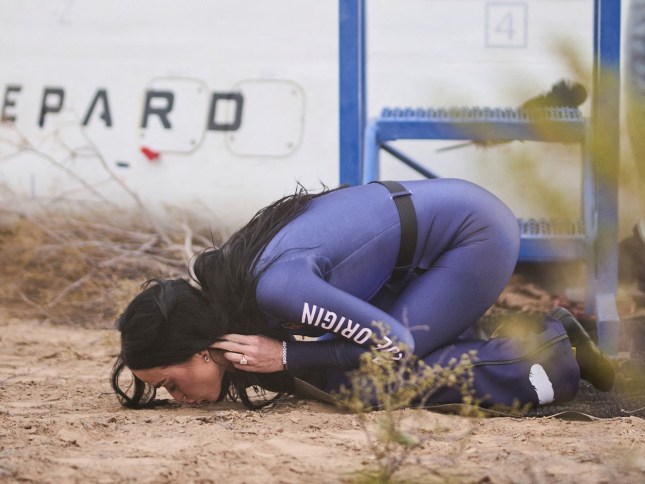 This handout photo from Blue Origin shows US singer Katy Perry kissing the ground upon return to Earth after a flight on Blue Origin New Shepard NS-31, which brought the passengers beyond the Karman line -- the internationally recognized boundary of space, in Van Horn, West Texas, April 14, 2025. Pop star Katy Perry completed a brief foray into space Monday, roaring to the edge of the cosmos with an all-women crew on one of billionaire Jeff Bezos's rockets. The "Firework" and "California Gurls" singer was lofted more than 60 miles (100 kilometers) above the Earth's surface in a vessel from Blue Origin, the space company owned by the Amazon founder. Five other women -- including Bezos's fiancee Lauren Sanchez -- were on the flight, which took off from western Texas shortly after 8:30 am (1330 GMT) before safely landing again some (Photo by Handout / BLUE ORIGIN / AFP) / RESTRICTED TO EDITORIAL USE - MANDATORY CREDIT "AFP PHOTO / HANDOUT / BLUE ORIGIN " - NO MARKETING NO ADVERTISING CAMPAIGNS - DISTRIBUTED AS A SERVICE TO CLIENTS (Photo by HANDOUT/BLUE ORIGIN/AFP via Getty Images)