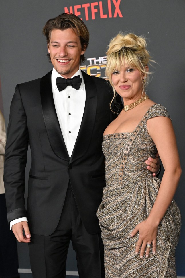 British actress Millie Bobby Brown (R) and her husband US actor Jake Bongiovi arrive for the world premiere of Netflix's "The Electric State" at The Egyptian Theatre in Los Angeles on February 24, 2025. (Photo by LISA O'CONNOR / AFP) (Photo by LISA O'CONNOR/AFP via Getty Images)