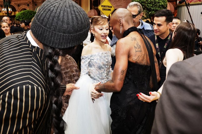 This picture by The Straits Times taken November 13, 2025 and provided on November 14 shows stars Ariana Grande (C) and Cynthia Erivo (2nd R) at the premiere of their film "Wicked: For Good" in Singapore. Singapore authorities charged an Australian man November 14 for rushing pop diva Ariana Grande at the Asia premiere of her latest movie, as outraged fans called for the alleged serial intruder "to be dealt with". (Photo by The Straits Times / AFP) / - Singapore OUT / -----EDITORS NOTE --- RESTRICTED TO EDITORIAL USE - MANDATORY CREDIT "AFP PHOTO / THE STRAITS TIMES - NO MARKETING - NO ADVERTISING CAMPAIGNS - DISTRIBUTED AS A SERVICE TO CLIENTS - NO ARCHIVES (Photo by STR/The Straits Times/AFP via Getty Images)