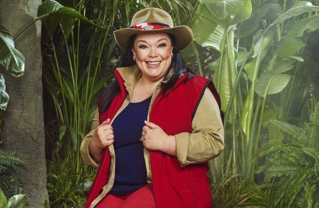 Lisa Riley posing in a red, navy and beige jungle outfit in her I'm A Celebrity promo.